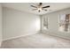 Neutral bedroom featuring natural light, a ceiling fan, and carpeted floors at 6268 Braidwood Nw Run, Acworth, GA 30101