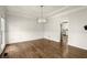 Dining area with white walls, trim, hardwood floors, and a modern chandelier at 6268 Braidwood Nw Run, Acworth, GA 30101