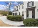 Charming two-story home with a white brick exterior, manicured landscaping, and a two-car garage at 6268 Braidwood Nw Run, Acworth, GA 30101