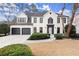 Charming two-story home with a white brick exterior, manicured landscaping, and a two-car garage at 6268 Braidwood Nw Run, Acworth, GA 30101