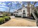 Charming two-story home with a white brick exterior, manicured landscaping, and a two-car garage at 6268 Braidwood Nw Run, Acworth, GA 30101
