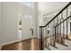 Bright foyer with hardwood floors, elegant staircase, and an arched transom over the front door at 6268 Braidwood Nw Run, Acworth, GA 30101