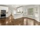 Bright eat-in kitchen features an island, stainless appliances, and gorgeous wood floors at 6268 Braidwood Nw Run, Acworth, GA 30101
