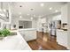 Kitchen with stainless steel appliances, an island, white countertops, and a view to the living room at 6268 Braidwood Nw Run, Acworth, GA 30101