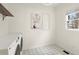 Well-lit laundry room with modern appliances, decorative floors and a large window for natural light at 6268 Braidwood Nw Run, Acworth, GA 30101