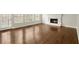 Light living area featuring hardwood floors, a fireplace, and access to the outdoors at 6268 Braidwood Nw Run, Acworth, GA 30101
