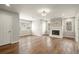 Cozy living room with hardwood flooring, large windows, and a classic fireplace at 6268 Braidwood Nw Run, Acworth, GA 30101