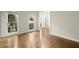 Light-filled living room with gleaming hardwood floors, white trim and ample natural light at 6268 Braidwood Nw Run, Acworth, GA 30101