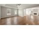 Open-concept living room with hardwood floors, fireplace, and natural light from multiple windows at 6268 Braidwood Nw Run, Acworth, GA 30101