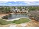 Scenic aerial view of a community pond with a sandy beach and golf course views at 6268 Braidwood Nw Run, Acworth, GA 30101