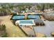 Aerial view featuring community tennis courts, pool, playground, and clubhouse with parking area at 6268 Braidwood Nw Run, Acworth, GA 30101