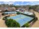 Aerial view showcasing well-maintained tennis courts, community pool, and clubhouse for recreational enjoyment at 6268 Braidwood Nw Run, Acworth, GA 30101