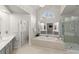 Elegant bathroom with a soaking tub, glass-enclosed shower, and double vanities for a spa-like experience at 650 Vinings Estates Se Dr, Mableton, GA 30126