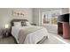 Cozy bedroom with plush bedding, natural light, and neutral tones for a relaxing atmosphere at 650 Vinings Estates Se Dr, Mableton, GA 30126