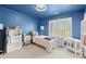 Charming bedroom with blue walls, a window view, and stylish furniture at 650 Vinings Estates Se Dr, Mableton, GA 30126