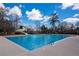 A community pool with a slide, surrounded by trees and a blue sky with clouds at 650 Vinings Estates Se Dr, Mableton, GA 30126