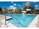 Large community pool with a slide and a separate shallow section for children at 650 Vinings Estates Se Dr, Mableton, GA 30126