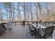 A spacious outdoor deck showcases a dining table and overlooks surrounding trees at 650 Vinings Estates Se Dr, Mableton, GA 30126