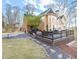 A sprawling two-story home with a large deck, a well-manicured lawn, and a beautiful stone pathway at 650 Vinings Estates Se Dr, Mableton, GA 30126