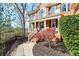 A stunning brick home featuring a columned porch, black shutters, and professionally landscaped yard at 650 Vinings Estates Se Dr, Mableton, GA 30126