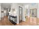 Inviting foyer with hardwood floors, a console table, and a view of the front door and staircase at 650 Vinings Estates Se Dr, Mableton, GA 30126