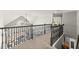 Elegant hallway with decorative railing, chandelier, and an open view of the living space below at 650 Vinings Estates Se Dr, Mableton, GA 30126