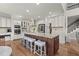 Gourmet kitchen features a center island with seating, stainless steel appliances, and custom cabinetry at 650 Vinings Estates Se Dr, Mableton, GA 30126