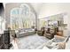 Bright living room with tall arched windows, fireplace, and open floor plan to the kitchen at 650 Vinings Estates Se Dr, Mableton, GA 30126