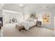 Spacious primary bedroom with tray ceilings, large windows, and a seating area for ultimate comfort at 650 Vinings Estates Se Dr, Mableton, GA 30126