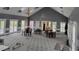 A large gathering room in neutral colors with several tables and chairs and two chandeliers at 650 Vinings Estates Se Dr, Mableton, GA 30126