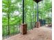 Outdoor patio with brick flooring and black metal railings overlooking a lush landscape at 650 Vinings Estates Se Dr, Mableton, GA 30126