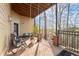 Relaxing outdoor patio with comfortable seating, a swing, and a scenic view of the surrounding greenery at 650 Vinings Estates Se Dr, Mableton, GA 30126
