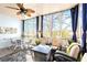Relaxing sunroom with ceiling fan and wooded views at 650 Vinings Estates Se Dr, Mableton, GA 30126