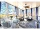 Relaxing sunroom with lots of natural light, ceiling fan, comfortable seating, and wooded views at 650 Vinings Estates Se Dr, Mableton, GA 30126