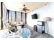 Sunroom with ceiling fan, TV, and mini refrigerator at 650 Vinings Estates Se Dr, Mableton, GA 30126