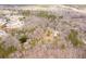 Panoramic aerial view showing a property nestled amidst trees near a quiet residential neighborhood at 8951 Brewer Rd, Douglasville, GA 30134