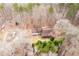 Aerial view of a home nestled among trees, showcasing its secluded location and spacious lot at 8951 Brewer Rd, Douglasville, GA 30134