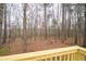View of the wooded backyard from the wooden deck of the home at 8951 Brewer Rd, Douglasville, GA 30134