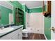 Charming bathroom with bright green walls and a tub with shower at 8951 Brewer Rd, Douglasville, GA 30134