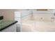 Bright bathroom with a tiled corner tub for a relaxing soaking experience at 8951 Brewer Rd, Douglasville, GA 30134