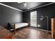 Bedroom with hardwood floors, large window and modern black walls at 8951 Brewer Rd, Douglasville, GA 30134