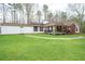 Quaint single Gathering home with a covered porch, beautiful green lawn and peaceful setting at 8951 Brewer Rd, Douglasville, GA 30134