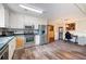 Bright eat-in kitchen features white cabinets, stainless steel appliances and hardwood floors at 8951 Brewer Rd, Douglasville, GA 30134