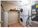 Practical laundry room featuring a stacked washer and dryer unit at 8951 Brewer Rd, Douglasville, GA 30134