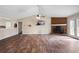 Large living room featuring a brick fireplace, wood-look flooring and access to the deck at 8951 Brewer Rd, Douglasville, GA 30134
