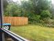 Well-maintained backyard featuring a wooden fence and lush green lawn and view from the window at 312 Lauren Dr, Fairburn, GA 30213
