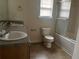Bathroom featuring double sinks, a toilet, and a shower with glass doors at 312 Lauren Dr, Fairburn, GA 30213