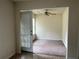Cozy bedroom with neutral walls, carpeting, ceiling fan and door to outside with blinds at 312 Lauren Dr, Fairburn, GA 30213