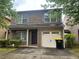 Charming two-story brick home with gray shutters, well-manicured lawn, and attached one-car garage at 312 Lauren Dr, Fairburn, GA 30213