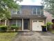 Charming two-story brick home with gray shutters, well-manicured lawn, and attached one-car garage at 312 Lauren Dr, Fairburn, GA 30213